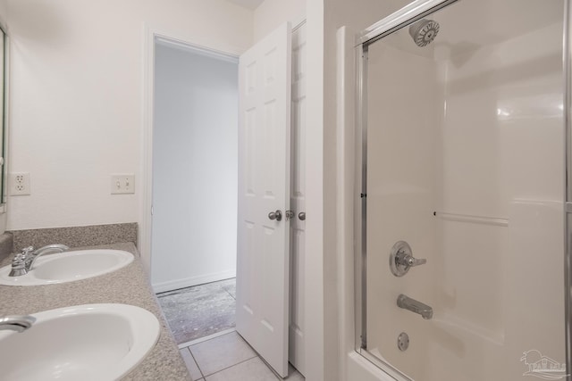 bathroom with tile patterned flooring, vanity, and combined bath / shower with glass door