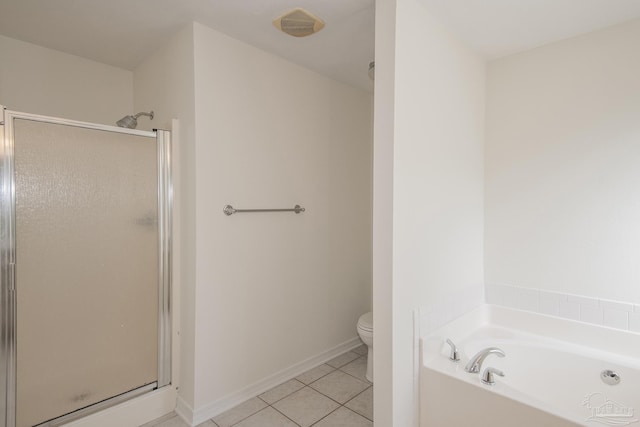 bathroom with tile patterned floors, toilet, and separate shower and tub