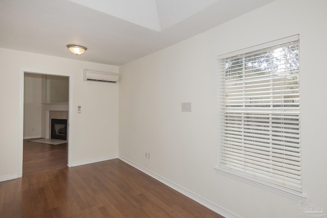 unfurnished room featuring dark hardwood / wood-style floors and a wall mounted AC