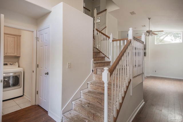 stairs featuring ceiling fan, washer / dryer, and hardwood / wood-style floors