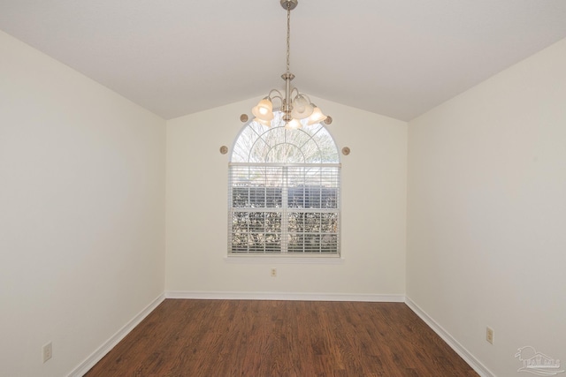 spare room with lofted ceiling, dark wood-type flooring, and a notable chandelier