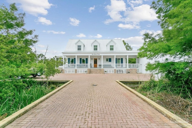 view of front of home featuring covered porch and metal roof