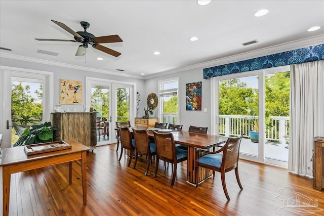 dining room with visible vents, a wealth of natural light, and hardwood / wood-style flooring