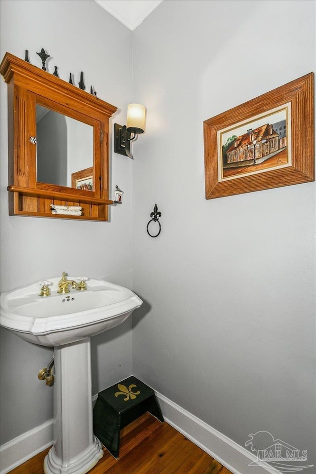 bathroom featuring baseboards and wood finished floors