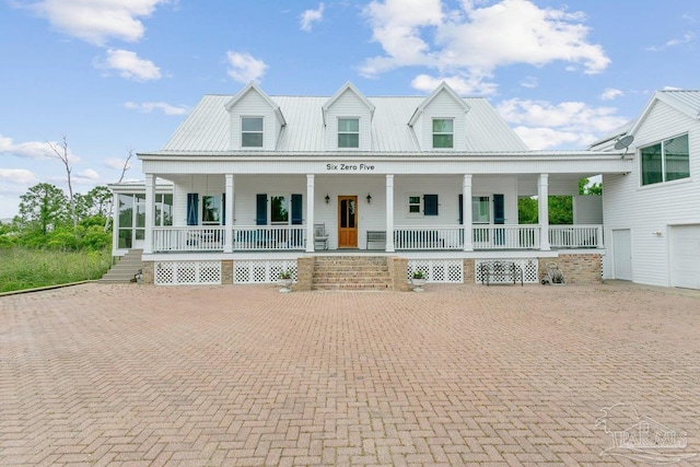 view of front of home with a porch and metal roof