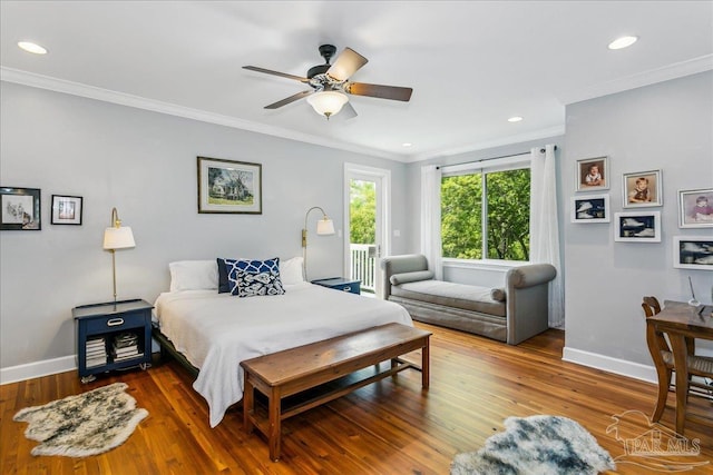 bedroom with crown molding, baseboards, and hardwood / wood-style floors