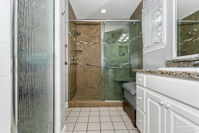 bathroom featuring tile patterned flooring, recessed lighting, vanity, and a shower stall