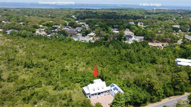 birds eye view of property with a wooded view