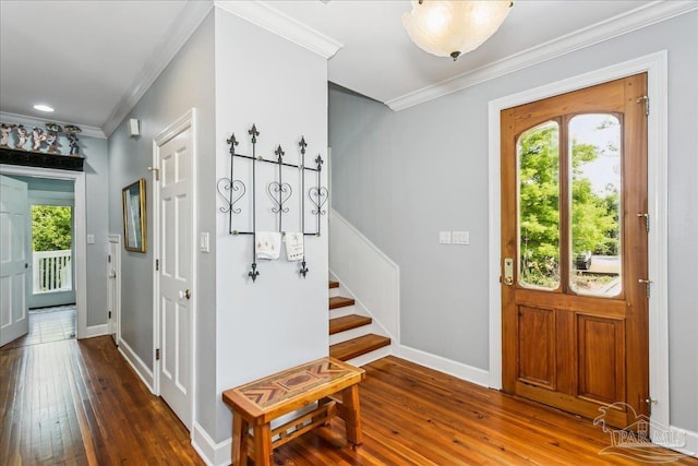 foyer featuring crown molding, baseboards, and hardwood / wood-style flooring