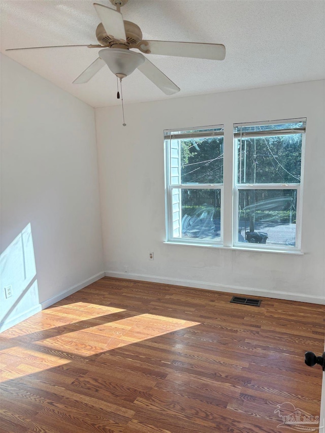 unfurnished room featuring a textured ceiling, hardwood / wood-style flooring, and ceiling fan