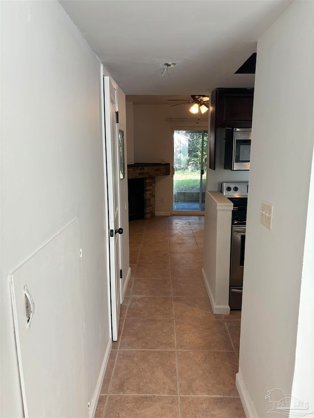 hall featuring light tile patterned floors