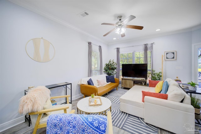 living room featuring crown molding, ceiling fan, and wood-type flooring