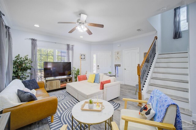 living room with ornamental molding, ceiling fan, and hardwood / wood-style floors