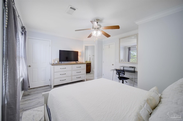 bedroom featuring light hardwood / wood-style flooring, connected bathroom, ceiling fan, and crown molding