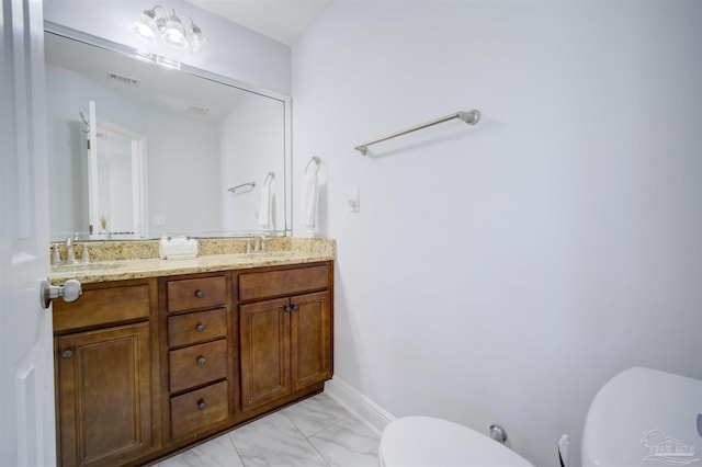 bathroom featuring dual vanity, tile patterned flooring, and toilet