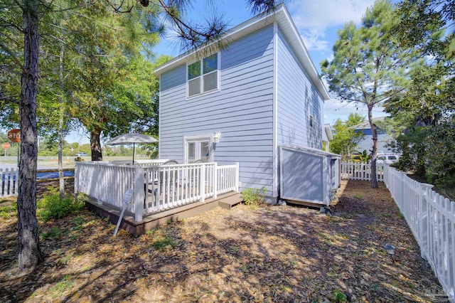 rear view of house with a wooden deck