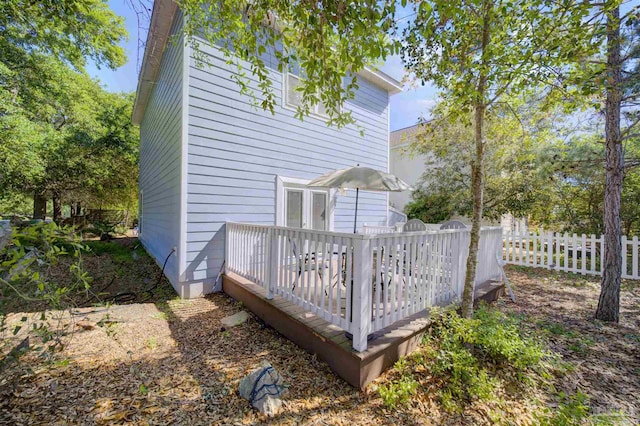 back of house with a wooden deck