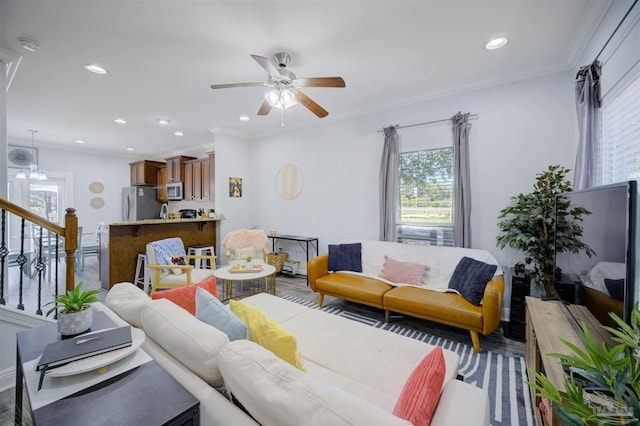 living room with crown molding, ceiling fan, and wood-type flooring