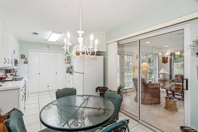 tiled dining space featuring a chandelier