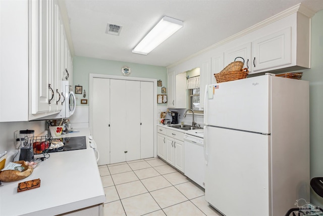 kitchen featuring white cabinets, white appliances, light tile patterned floors, and sink