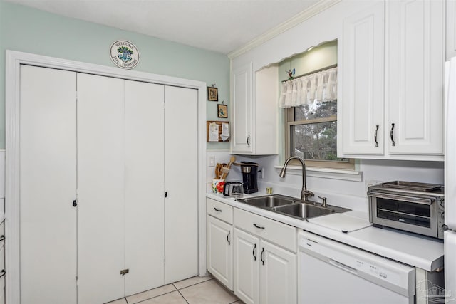 kitchen with light tile patterned flooring, sink, ornamental molding, white dishwasher, and white cabinets