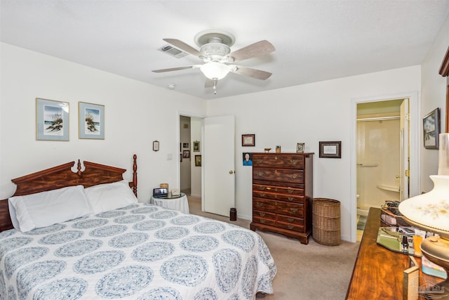 carpeted bedroom with ceiling fan and ensuite bath