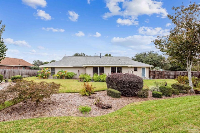 rear view of property featuring a yard