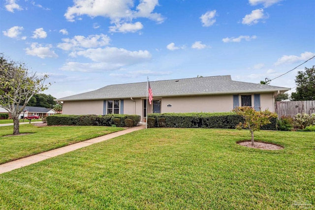 ranch-style home with a front lawn