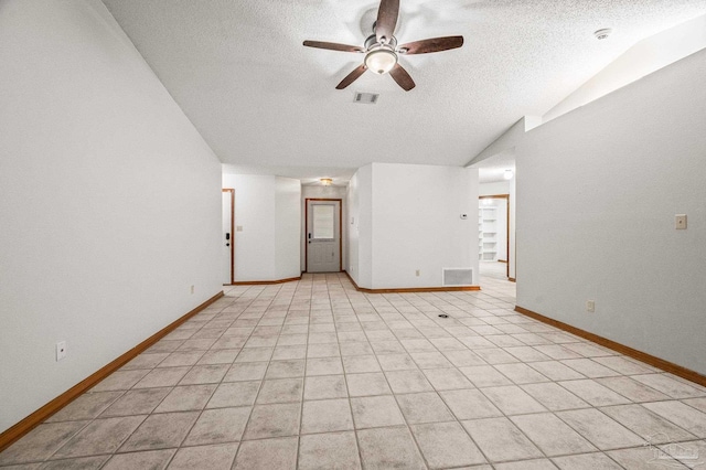 4420 Bellwood Cir, Pace, FL 32571 - spare room featuring a ceiling fan, a textured ceiling, a smoke detector, vaulted ceiling, and light tile patterned floors
