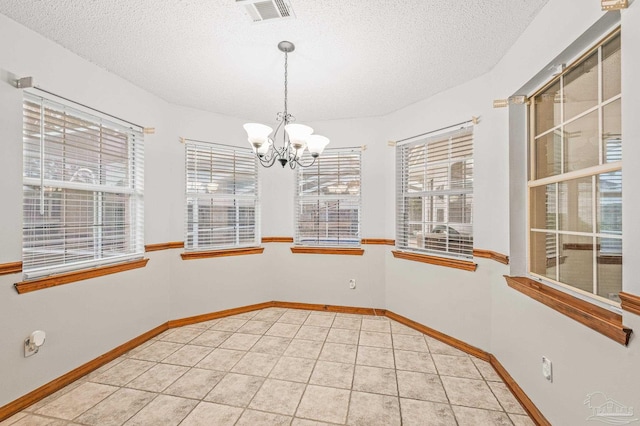 4420 Bellwood Cir, Pace, FL 32571 - empty room with a chandelier, a textured ceiling, and light tile patterned floors
