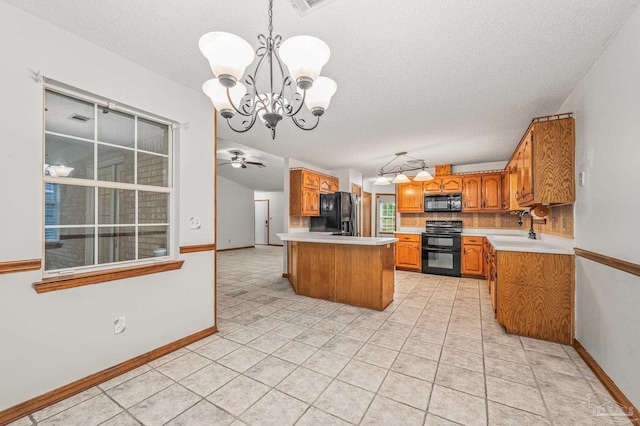 4420 Bellwood Cir, Pace, FL 32571 - kitchen with black appliances, a chandelier, a textured ceiling, brown cabinetry, and light countertops