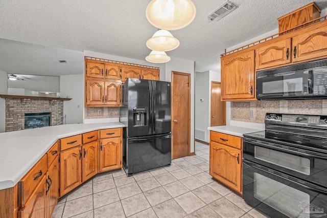 4420 Bellwood Cir, Pace, FL 32571 - kitchen featuring black appliances, light countertops, a textured ceiling, decorative backsplash, and light tile patterned floors