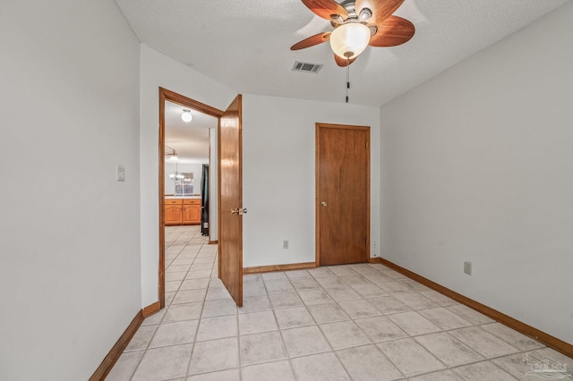4420 Bellwood Cir, Pace, FL 32571 - unfurnished room with ceiling fan, light tile patterned flooring, and a textured ceiling
