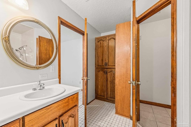 4420 Bellwood Cir, Pace, FL 32571 - bathroom with vanity, tile patterned flooring, and a textured ceiling