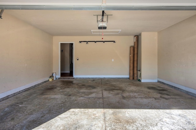 garage with baseboards and a garage door opener