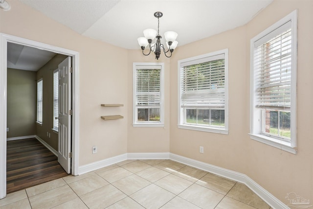 5833 Pebble Ridge Dr, Milton, FL 32583 - unfurnished dining area with a chandelier, light tile patterned flooring, and healthy amount of natural light