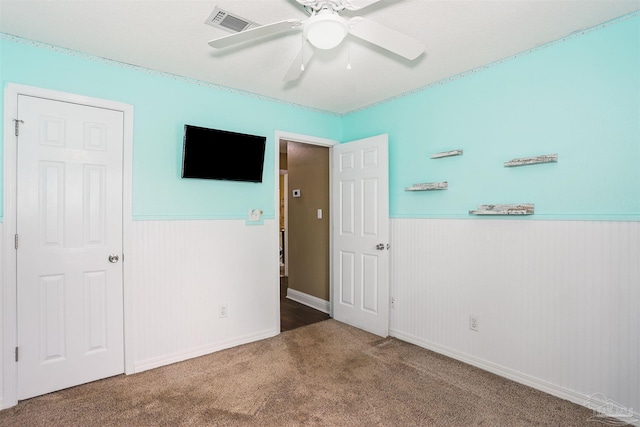 5833 Pebble Ridge Dr, Milton, FL 32583 - unfurnished bedroom with carpet flooring, wainscoting, and ceiling fan