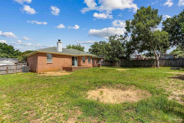 5833 Pebble Ridge Dr, Milton, FL 32583 - back of house with brick siding, a fenced backyard, and a chimney