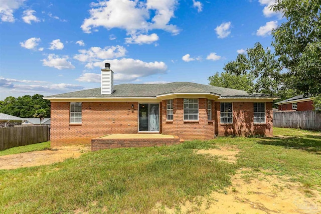 5833 Pebble Ridge Dr, Milton, FL 32583 - rear view of house featuring a fenced backyard, a chimney, and brick siding