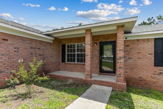 5833 Pebble Ridge Dr, Milton, FL 32583 - view of exterior entry featuring brick siding and a shingled roof