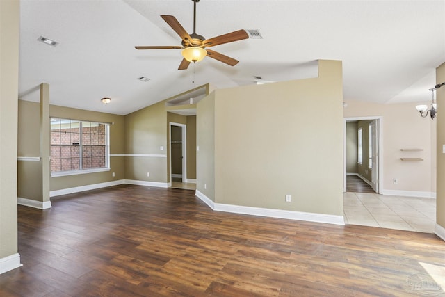 5833 Pebble Ridge Dr, Milton, FL 32583 - unfurnished room with vaulted ceiling, a ceiling fan, a chandelier, and wood finished floors
