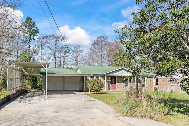 view of front facade with a carport, a front yard, and a garage