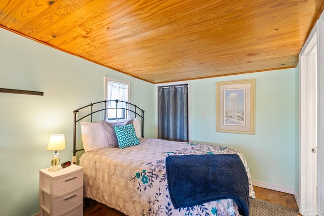 bedroom featuring hardwood / wood-style flooring, crown molding, and wood ceiling