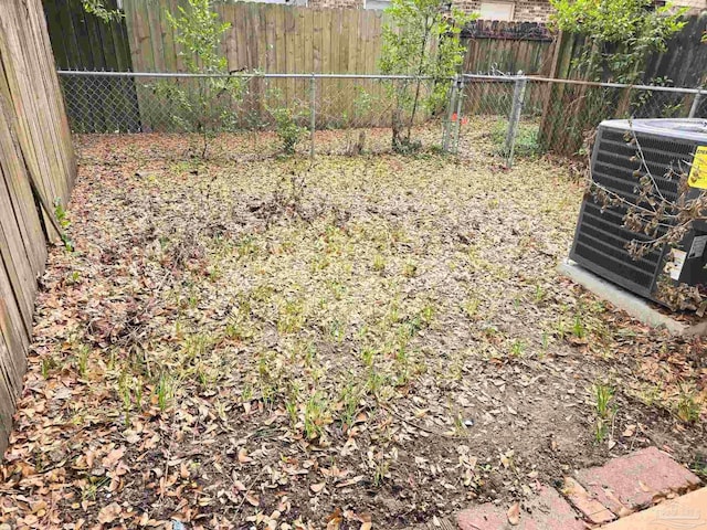 view of yard featuring a fenced backyard and central air condition unit