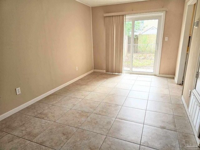 spare room with light tile patterned floors, visible vents, and baseboards