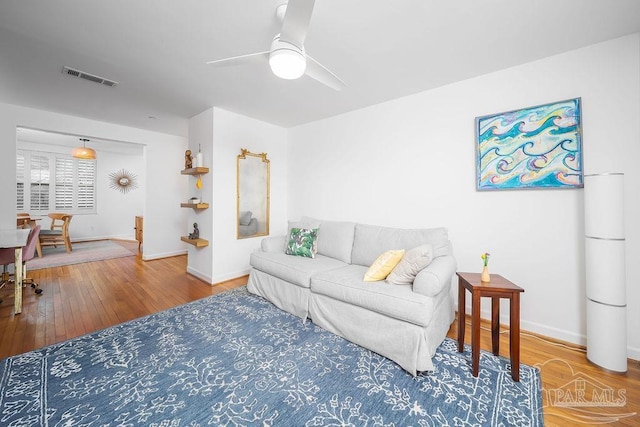 2007 E Gadsden St Unit 105, Pensacola, FL 32501 - living room featuring a ceiling fan, baseboards, and wood finished floors