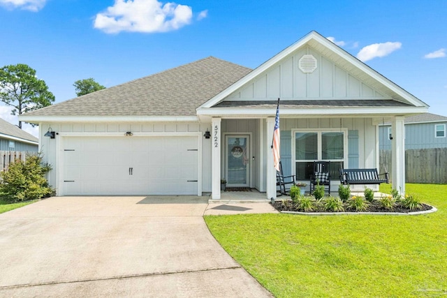 5722 Conley Ct, Pace, FL 32571 - view of front facade with board and batten siding, an attached garage, a shingled roof, driveway, and a porch