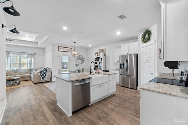 5722 Conley Ct, Pace, FL 32571 - kitchen featuring stainless steel appliances, light wood-type flooring, a sink, white cabinets, and recessed lighting
