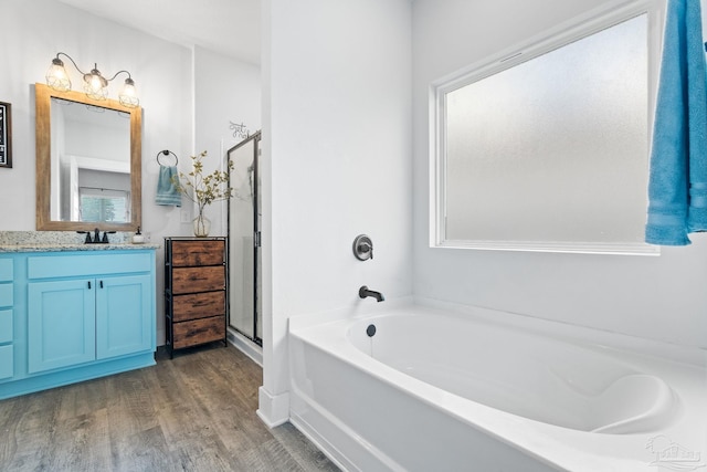 5722 Conley Ct, Pace, FL 32571 - full bathroom featuring a bath, vanity, wood finished floors, and a shower stall