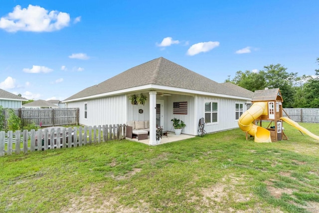 5722 Conley Ct, Pace, FL 32571 - back of property featuring outdoor lounge area, a playground, a patio area, a shingled roof, and board and batten siding
